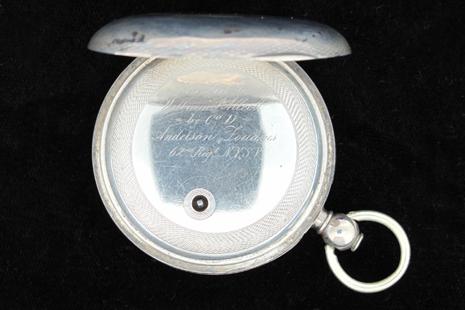 photo of the inside case of William P. Allcott's pocket watch. engraving revealed