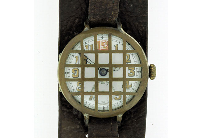 photo of George Henry Beamish's trenchwatch fitted with trench guard and leather strap.