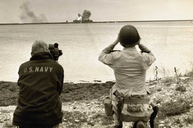 Fred Gerretson and a spotter taking fotage of an explosion.